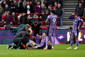 Liverpool's Diogo Jota received medical attention after suffering a knee injury in the Premier League game against Brentford on Saturday