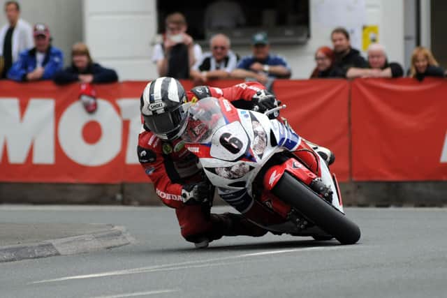 Michael Dunlop on his way to victory in the Superbike race at the Isle of Man TT on the Honda Legends Fireblade in 2013.