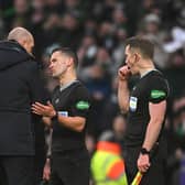 Rangers manager Philippe Clement speaks with referee Nick Walsh after the cinch Premiership match against Celtic at Parkhead
