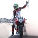 Glenn Irwin celebrates with a one-handed burnout after winning the feature NW200 Superbike race for a unique treble