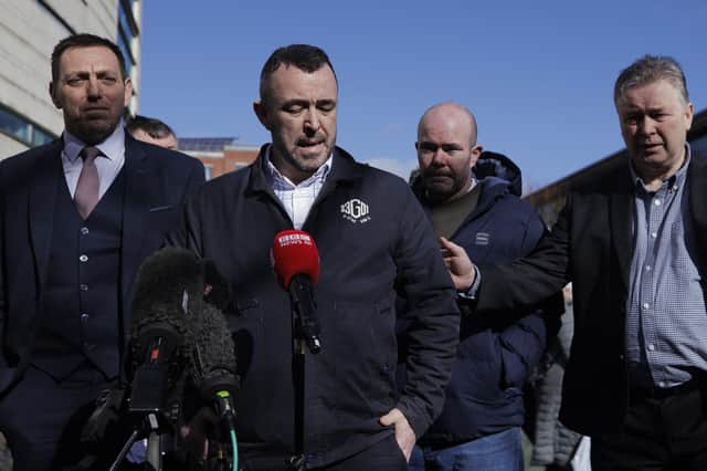 Kieran Fox (second from left), son of Eamon Fox, is comforted during a press conference outside Belfast Crown Court by a family member as he gives his reaction to James Smyth being found not guilty of the murders of his father Eamon Fox and Gary Convie in 1994. Pic: Liam McBurney/PA Wire