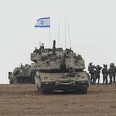 Israeli soldiers are seen in a staging ground near the Israeli Gaza border, southern Israel, on Monday