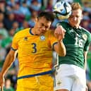 Ali McCann of Northern Ireland wins a header against Nuraly Alip of Kazakhstan during the Euro 2024 qualifier between the two sides