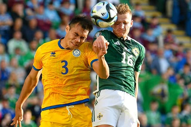 Ali McCann of Northern Ireland wins a header against Nuraly Alip of Kazakhstan during the Euro 2024 qualifier between the two sides