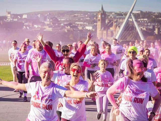 Runners, walkers, and pooches were splashed in pink powder from head to toe for a great cause as Cancer Focus NI’s first Pink Run took place in Londonderry. Picture Steven McAuley/McAuley Multimedia