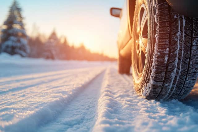 Leaving tread marks in winter conditions, close-up of car tires on a snowy, icy road