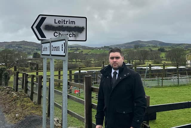 Alan Lewis, Slieve Croob DUP Councillor, standing beside the vandalised road sign which points to Leitrim Presbyterian Church. Mr Lewis said those responsible for the vandalism 'should be ashamed and thoroughly embarrassed by their actions.'