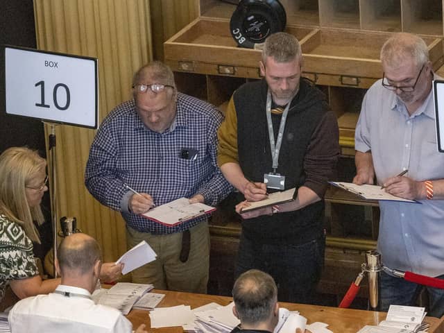 Green Party NI leaders Mal O'Hara (centre) tallying ballots as ballot boxes are opened in Belfast City Hall. He later lost his seat to Carl Whyte of the SDLP