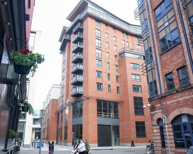 A general view of the Victoria Square apartments in Belfast, the central red brick building. Owners had to evacuate in 2019 due to a flawed support column. Photo by Jonathan Porter/Press Eye