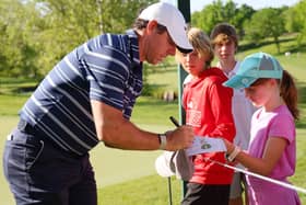 Northern Ireland’s Rory McIlroy signs an autograph for a young fan during the Golden Bear Pro-Am prior to the Memorial Tournament at Muirfield Village