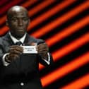 Stephane Mbia, from Cameroon, shows the ticket with the name of Rangers FC during the 2023/24 UEFA Europa League group stage draw at the Grimaldi Forum in Monaco
