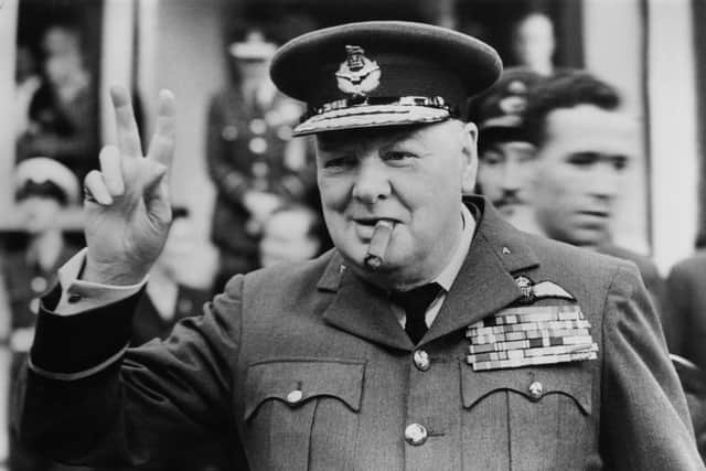 Winston Churchill (1874 - 1965) gives his famous v-sign as he opens the new headquarters of 615 (County of Surrey) Squadron of the RAAF (Royal Auxiliary Air Force) at Croydon, 1948. (Photo by Central Press/Hulton Archive/Getty Images)