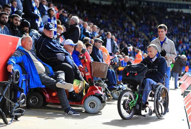 Disabled football fans at a match.