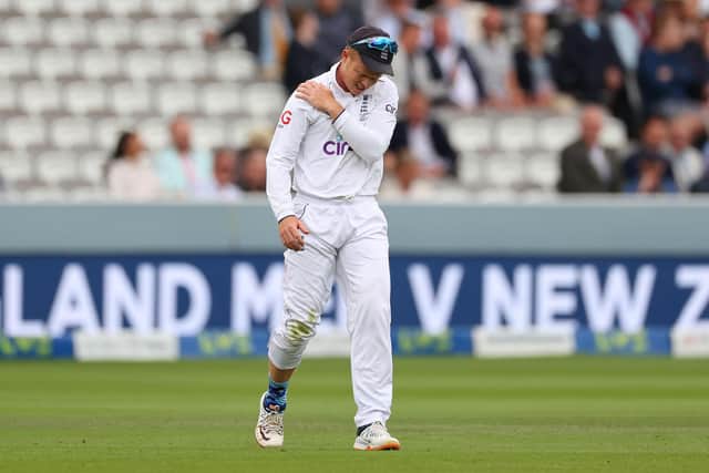 England's Ollie Pope leaves the field while clutching his shoulder after going down with an injury during Day Three of the Ashes 2nd Test at Lord's.