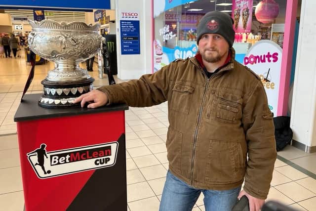The BetMcLean Cup spent time in Portadown's Meadows Shopping Centre recently as part of the build-up to the final against Linfield, with Stephen Troughton one of the fans happy to check out the trophy. (Photo by National World)