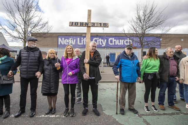 Belfast Lord Mayor Tina Black (4th left) and Joe Murphy carrying a cross, taking part in Worship Between the Gates, part of the Human Peace Wall by the New Life City Church on Northumberland Street in Belfast, between the Shankill and the Falls Road