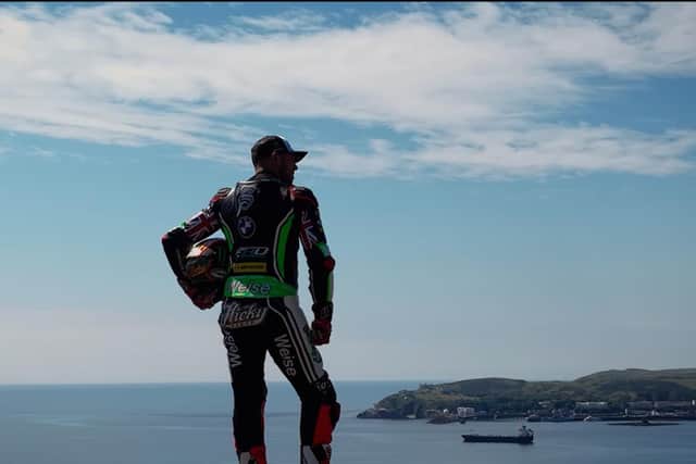 A still from Tourist Trophy as Peter Hickman gazes over Douglas Bay at the 2022 Isle of Man TT races.