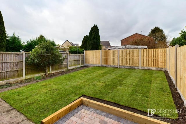 Our final photo shows the lawned garden at the back of the house, and a block-paved patio area. The borders are gravelled, and there are also an outside tap and external light.