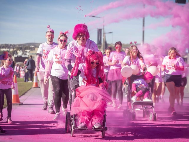 Runners, walkers, and pooches were splashed in pink powder from head to toe for a great cause as Cancer Focus NI’s first Pink Run took place in Londonderry. Picture Steven McAuley/McAuley Multimedia