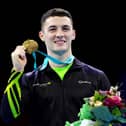 Northern Ireland's Rhys McClenaghan showing off gold during the medal ceremony for the Men's Pommel Horse Final on day eight of the 2023 Artistic Gymnastics World Championships at Antwerp Sportpaleis. (Photo by Naomi Baker/Getty Images)