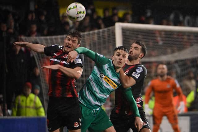 Crusaders' Philip Lowry (left) battling with Ryan Curran in the 2-2 derby draw against Cliftonville