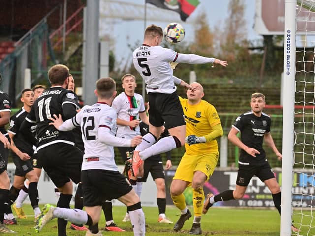 Aidan Wilson climbs highest to score the first of Glentoran's five goals against Ballymena United. PIC: Colm Lenaghan/Pacemaker