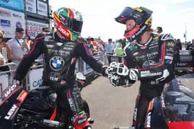 Peter Hickman (left) congratulates 8TEN Racing BMW team-mate Davey Todd on winning the Saturday Superstock race at the North West 200. (Photo by Stephen Davison/Pacemaker Press)
