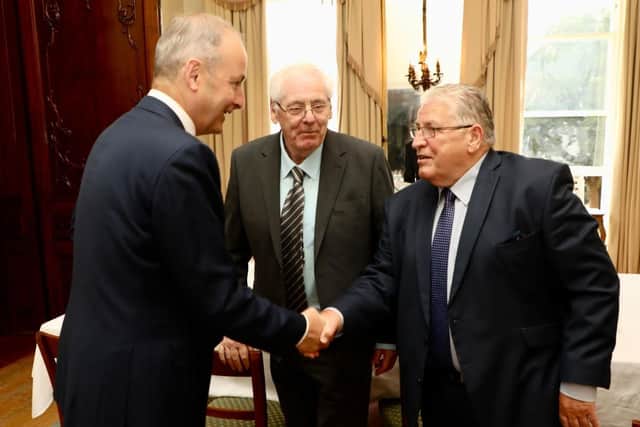 Omagh bomb campaigners Stanley McCombe (right) and Michael Gallagher (centre) meeting with Tanaiste Micheal Martin at Iveagh House, Dublin