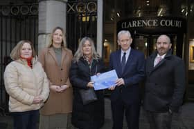 Monica Heaney (third from left), whose son, Karl Heaney, died in a collision on the A1 in 2018, with Alliance Party representatives David Honeyford MLA (right), the party's Infrastructure spokesperson, and Lisburn and Castlereagh Councillor Gretta Thompson (left), and Banbridge Councillor Joy Ferguson, present a petition for safety upgrades to the road to Department for Infrastructure Permanent (DfI) Secretary Dr. Denis McMahon (second from right) at the DfI Headquarters on Adelaide Street in Belfast