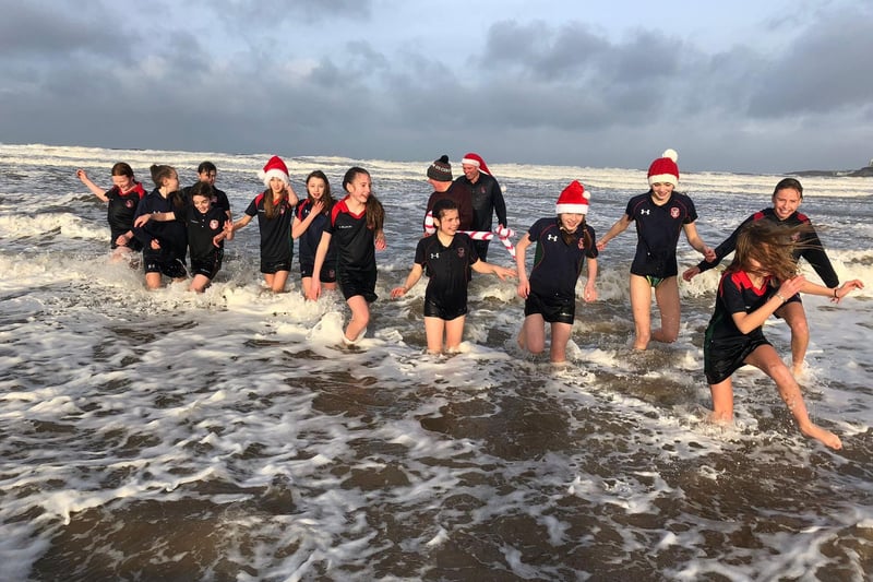 Braving the choppy waters during their sea dip debut on Portstewart Strand are Year 8 pupils from Coleraine Grammar School; Amber Miller, Anna McGreevy, Elise Archibald, Erin Semple, Eva Grace Patterson, Isabella McCarron, Jasmine Moore, Jessica Cartmill, Josie Dixon, Lucy Blackstock, Poppy Ewing, Sarah McCaughey and Tilly Lyttle with teachers Mr Semple and Mr Cartmill