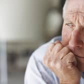 Closeup of a man looking away in deep thought , depression