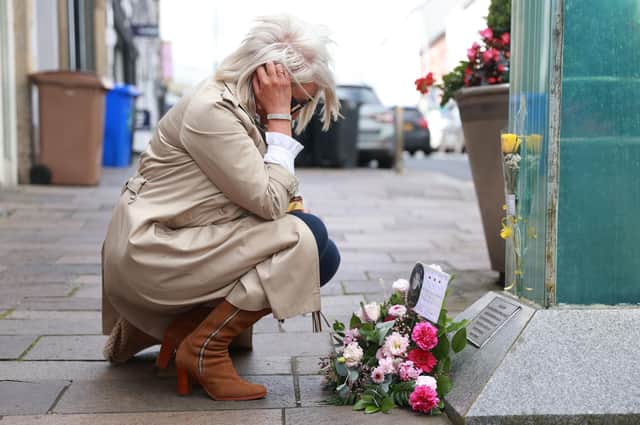 Caroline Martin, sister of Esther Gibson who died in the Omagh bombing, lays flowers at the site during Tuesday’s 25th anniversary event. Pic: Liam McBurney/PA Wire