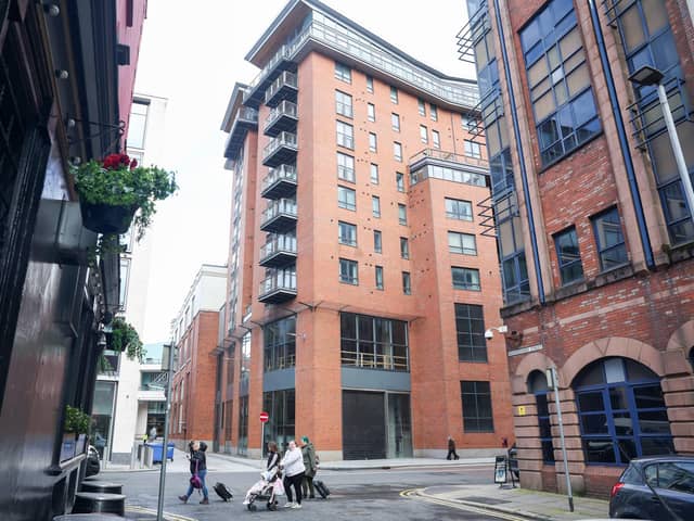 A general view of the Victoria Square apartments in Belfast, the central red brick building. Owners had to evacuate in 2019 after structural issues were found