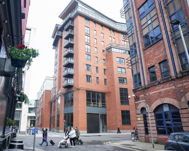 A general view of the Victoria Square apartments in Belfast, the central red brick building. Owners had to evacuate in 2019 after structural issues were found