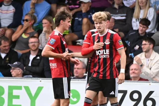 Owen Wardell celebrates his goal with his Crusaders team mates in the comeback victory against Ballymena United