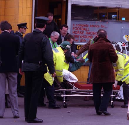 A seriously injured man is taken from Sean Grahams bookmakers on the Ormeau Road in Belfast after the UFF gun attack in 1992 killing 5 men.
PICTURE BY MARTIN WRIGHT/PACEMAKER