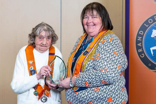 Phyllis Galloway, a member of Sister Turtle Memorial WLOL14, receives the Inspirational Orangewoman of the Year award from Julie Dodd, Grand Secretary ALOI