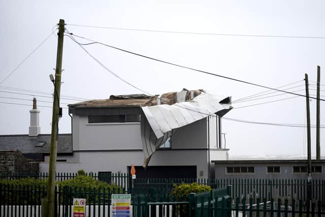 The scene in Youghal, Co Cork, where a roof was been blown from a building by Storm Agnes on Wednesay.
Photo credit should read: Niall Carson/PA Wire
