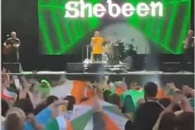Footage of the crowd joining in a chorus of the IRA chant 'Tiocfaidh ár lá' and 'Ooh ah up the Ra' at a support act to the Wolf Tones concert at Falls Park on Sunday August 13 the the west Belfast Féile an Phobail