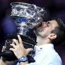 Novak Djokovic poses with the Norman Brookes Challenge Cup after beating Stefanos Tsitsipas to win the Australian Open at Melbourne Park on Suday. (Photo by Clive Brunskill/Getty Images)