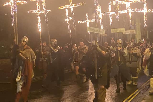 Fiery crosses are paraded through the streets of Lewes in East Sussex
