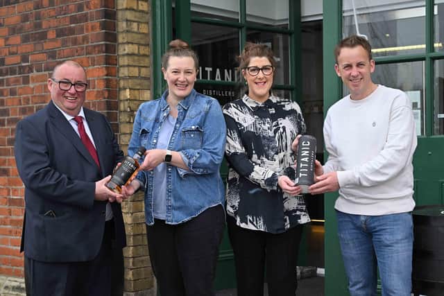 The first visitors through the door on opening day were Patricia Forsythe (left centre) from East Belfast and Lisa Kelly from Carrickfergus, who each received a complimentary bottle of whiskey from Titanic Distillers directors Peter Lavery (left) and Stephen Symington.