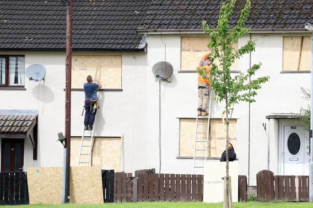 Windows are boarded up on houses next to the bonfire at Craigyhill. Photo by Jonathan Porter / Press Eye.