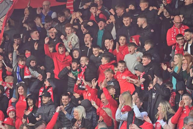 A surreal atmosphere enveloped Larne FC this week, as they prepared to lift the Irish League Cup for the first time ever. Pictured are fans at the 1-1 draw with Linfield on Friday night, ahead of the cup presentation. Pic: Colm Lenaghan