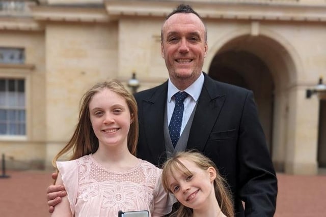 Michael Boyd OBE pictured at Buckingham Palace with his two daughters Rachel and Olivia