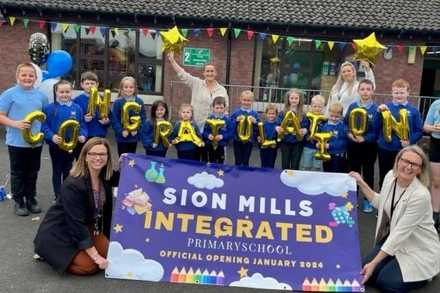 Pupils and staff at Sion Mills Primary School celebrating their successful parental ballot to transform to Integrated status.