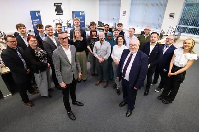 Pictured at Belfast Met at the launch of the assured skills academy date and analytics training course with EY and Belfast Met and funded by the Department of the Economy are: Rob Heron, managing partner, EY NI and Damian Duffy, deputy chief executive, Belfast Met and academy students attending the training course