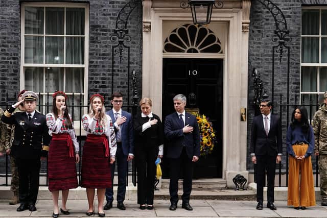 Ukrainian Ambassador to the UK, Vadym Prystaiko (centre) and his wife Inna Prystaiko (centre left), with Prime Minister Rishi Sunak (second right) and his wife Akshata Murty (right), members of the Ukrainian Armed Forces, outside 10 Downing Street, London, as they observe a minute's silence to mark the one-year anniversary of the Russian invasion of Ukraine. Picture date: Friday February 24, 2023.