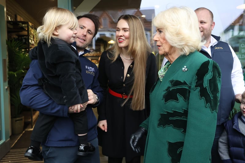 Queen Camilla (centre right) meets the owner of Knotts Bakery, William Corrie, his wife Zoe Salmon and their son Fitz during a visit to Lisburn Road in Belfast to meet shop owners and staff, and learn about their positive contribution to the community, during her two-day official visit to Northern Ireland.
