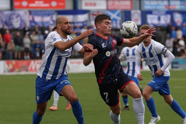 Darren Cole pays close attention to Hamilton's Euan Henderson during the clash at The Showgrounds